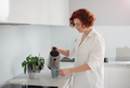 Young beautiful woman making morning coffee , preparing a cup of latte for breakfast - PhotoDune Item for Sale