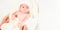 Adorable 6 months old Baby girl infant on a bed after bath - PhotoDune Item for Sale