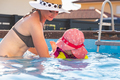 2-3 years old child with mother in swimming pool learn to swim. Summer at home concept. - PhotoDune Item for Sale