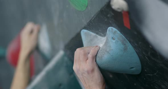 Man Climbs a Steep Wall, Training on a Climbing Wall, Practicing Rock-climbing, Moving Up in Slow