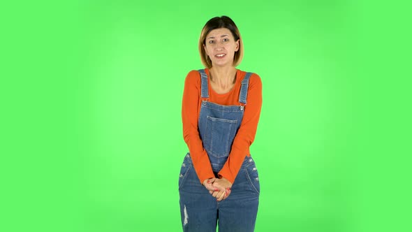 Girl Listens Carefully, Waving Her Hands in Indignation, Shrugs. Green Screen