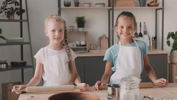 School Girls Standing at Kitchen Table 