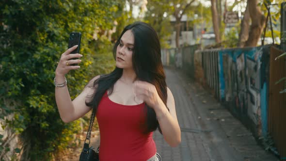 a Beautiful Trans Woman Takes Selfies Walking Down the Street