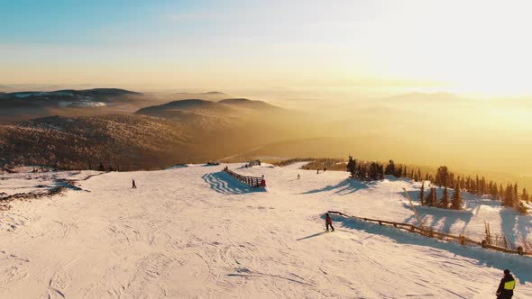 Amazing View From the Air at Sunset on the Ski Slope and Mountain Slopes Bathed in Magical Light and