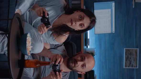 Vertical Video Focused Determined Couple Playing Video Game Late Night