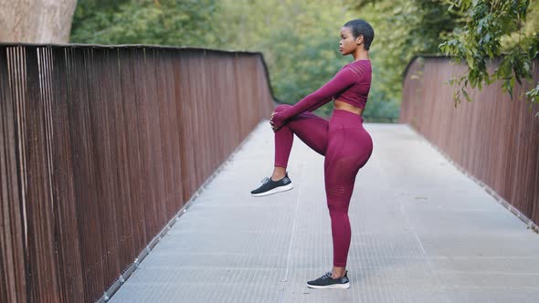 Athletic Mixed Race Girl Preparing for Daily Run Doing Stretching Exercises for Legs Knees