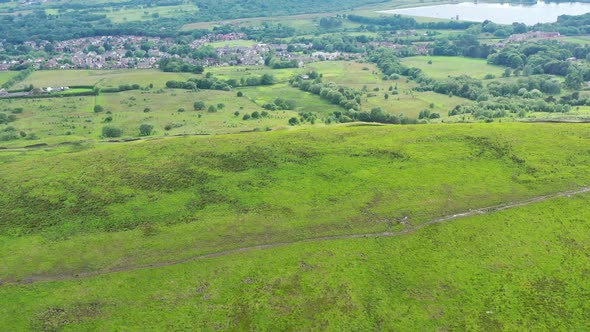 drone footage over a green golf course in England