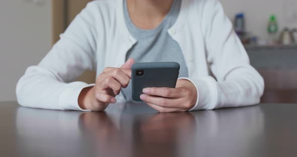 Woman use of cellphone at home