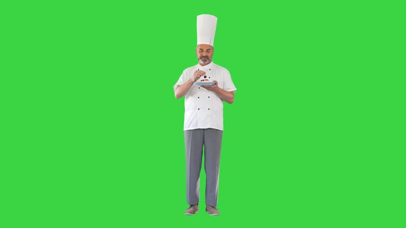 Pastry Chef Putting Cherry on Top of Dessert on a Green Screen Chroma Key