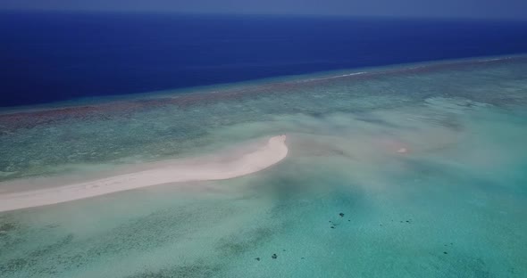 Beautiful drone tourism shot of a paradise sunny white sand beach and aqua blue water background