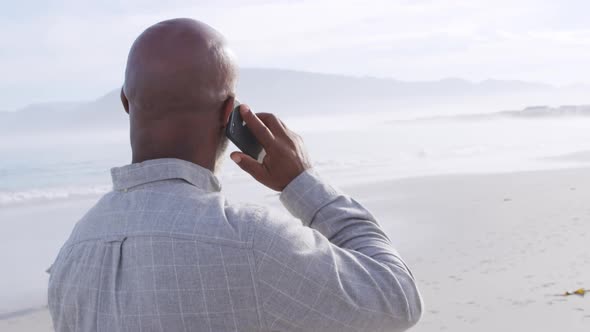 Mature man enjoying time outside by the sea