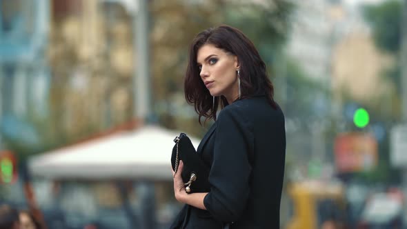 a Woman in a Business Suit Walks Around the City