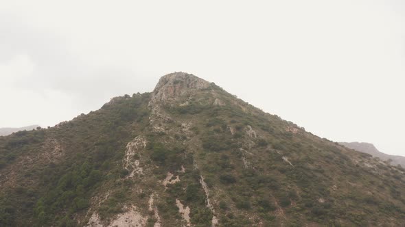 Drone Flight Arcing Round Mountain Peak