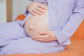 Pregnant woman keeps her hands on her belly - PhotoDune Item for Sale