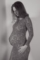 Beautiful young pregnant woman looking at her belly. - PhotoDune Item for Sale