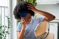 Cool African woman with comb sticking out of curly hair smiling looks in mirror and touches wig - PhotoDune Item for Sale