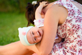 Mother holds infant baby girl and make her laugh to camera - PhotoDune Item for Sale
