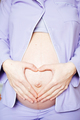 Close-up of Pregnant woman keeping her hands on belly. - PhotoDune Item for Sale