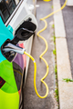 Modern electric cars EV Car plugged into charging station in city - PhotoDune Item for Sale