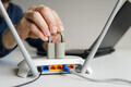 High speed wi-fi router with lock. Man using laptop on the background. - PhotoDune Item for Sale