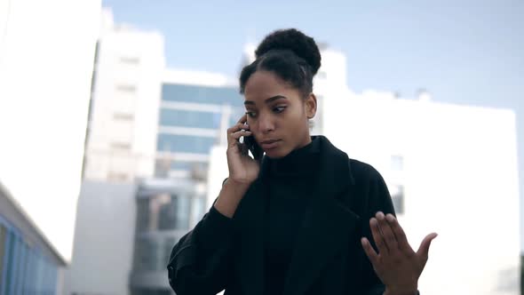 Low Angle Footage of Black Woman Talking on Mobile Phone Solving Business Issues Distantly