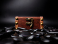 A locked mysterious wooden chest surrounded by black stones is on a black background. - PhotoDune Item for Sale