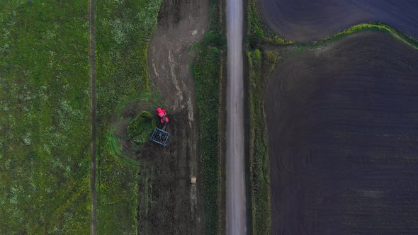 Red Tractor with  Plow in The Field