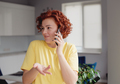 Happy casual beautiful woman is talking on a phone at home - PhotoDune Item for Sale