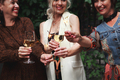 Happy Mature women Friends celebrate new year and laughing, hold sparklers and clink glasses - PhotoDune Item for Sale