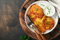 Potato pancakes. Fried homemade potato pancakes or latkes with cream and green onions in rustic plat - PhotoDune Item for Sale