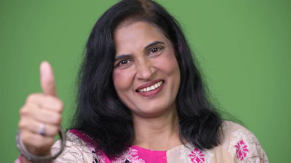 Close Up Shot of Mature Happy Beautiful Indian Woman Smiling While Giving Thumbs Up