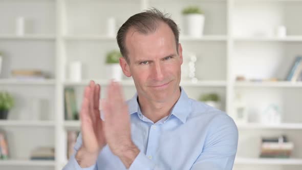 Portrait of Cheerful Middle Aged Businessman Clapping