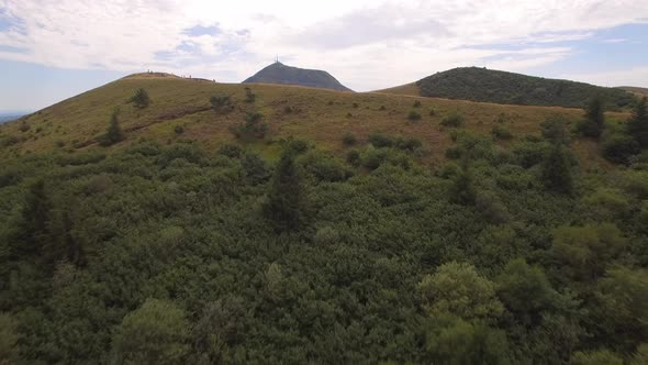 Aerial travel drone view of the Puy de Dome, lava dome volcano in France.