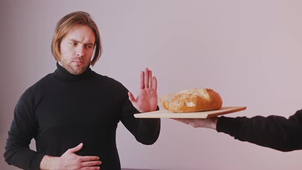 Young Caucasian Man on Low Card Diet Refusing To Take Bread Offered To Him