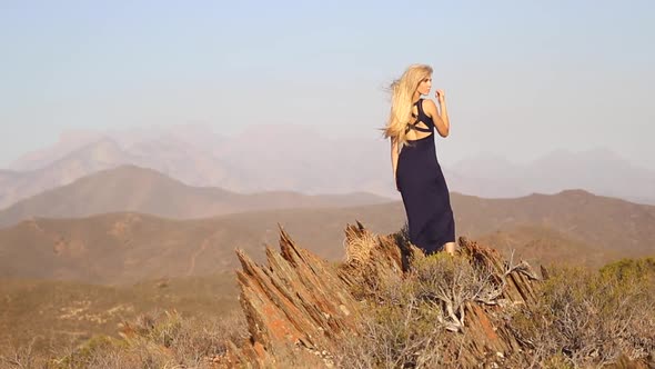 Beautiful blonde female model enjoying stunning scenery while traveling