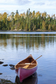 Wooden canoe near shore of Boundary Waters lake in Minnesota on an autumn morning - PhotoDune Item for Sale