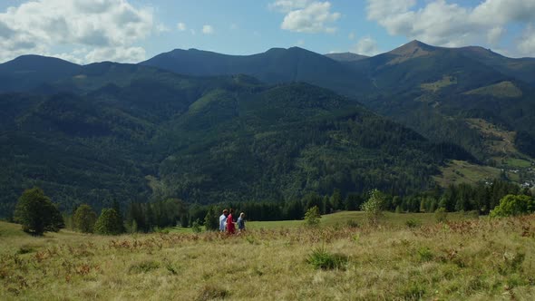 Children Parents Against Hills Walking Together Admiring Beautiful Landscape