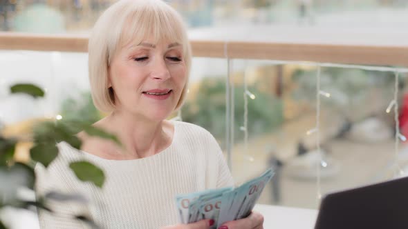 Closeup Mature Woman Bank Employee Financial Worker Sitting at Workplace Counting Cash Dollar Bills