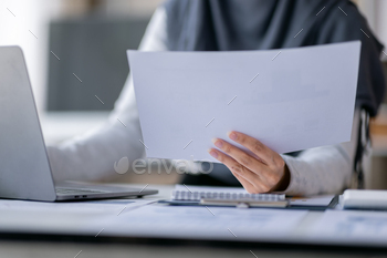 riting make note with calculate doing math finance on an office desk. Woman working at office with laptop and tax, accounting, documents on desk