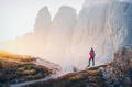 Young woman with backpack on the mountain trail and mountain - PhotoDune Item for Sale