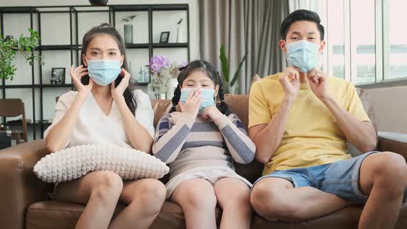 asian healthy wellness family wearing surgical facial mask together and stay home