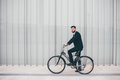 Contemporary bearded young stylish businessman going to work by bike - PhotoDune Item for Sale