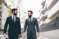 Two young elegant businessmen walking outdoors together - PhotoDune Item for Sale