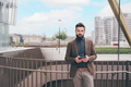 Young bearded man outdoors posing looking camera holding tablet - PhotoDune Item for Sale