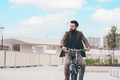 Contemporary bearded young stylish businessman going to work by bike - PhotoDune Item for Sale