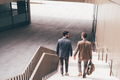 Two young businessmen outdoors walking downstairs - PhotoDune Item for Sale