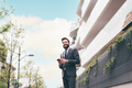 Young bearded elegant businessman outdoors using smartphone smiling - PhotoDune Item for Sale