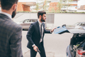 Contemporary elegant bearded businessman outdoors closing car trunk - PhotoDune Item for Sale