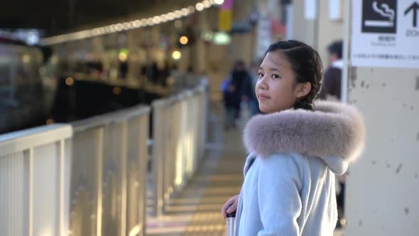 Asian Girl Waiting  Express Train On Railway Station