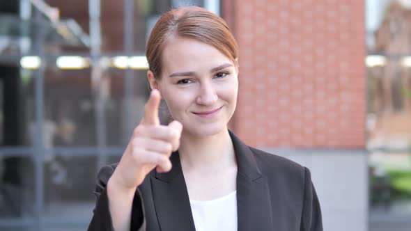 Young Businesswoman Pointing with Finger Outdoor